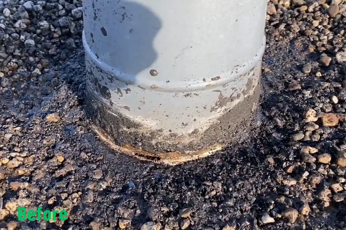 Flat roof pipe penetration with worn, cracked sealant before repair