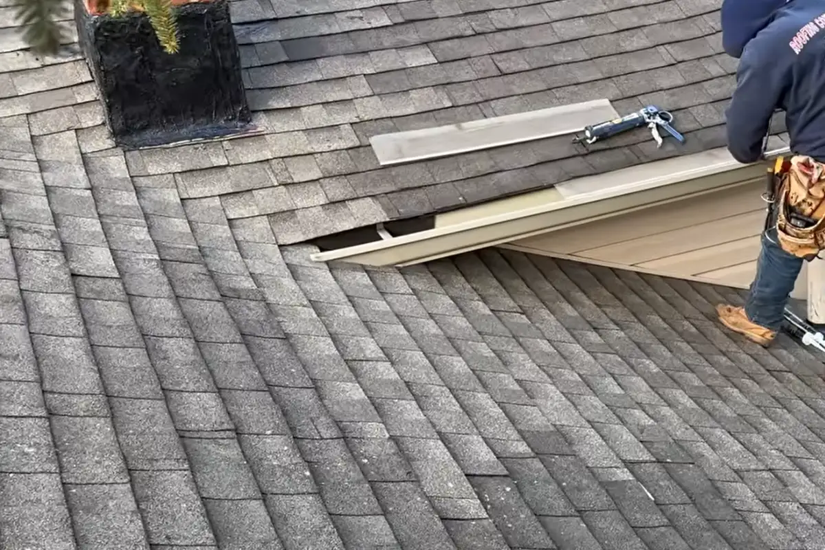 After repair: asphalt shingles installed around a repaired roof section